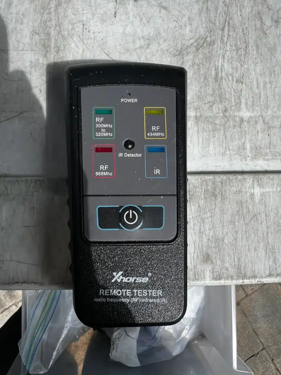 Transponder Key Programming Springdale AR: What to Know 2 Xhorse remote frequency tester used to verify key fob signal during automotive locksmith service in Springdale AR