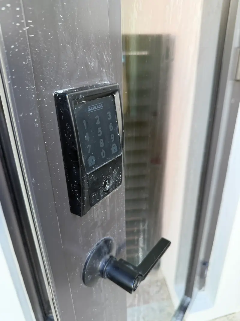 Commercial Door Lock Guide Texarkana AR: Access Control 4 Schlage commercial door lock keypad with lever handle on wet exterior commercial door in Texarkana AR showing weather resistance