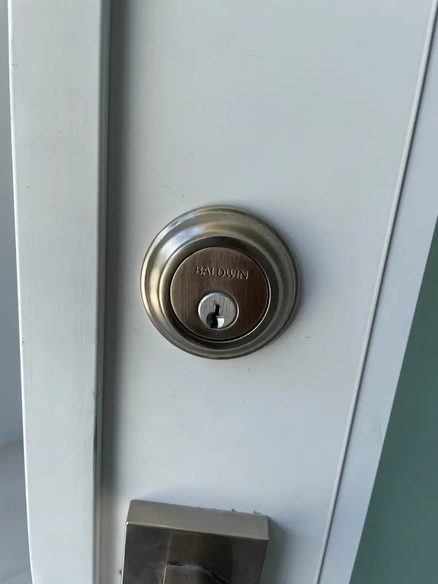New Home Rekey in El Dorado AR: What to Change Before Your First Night 3 Baldwin deadbolt on a residential front door ready for rekeying in El Dorado AR