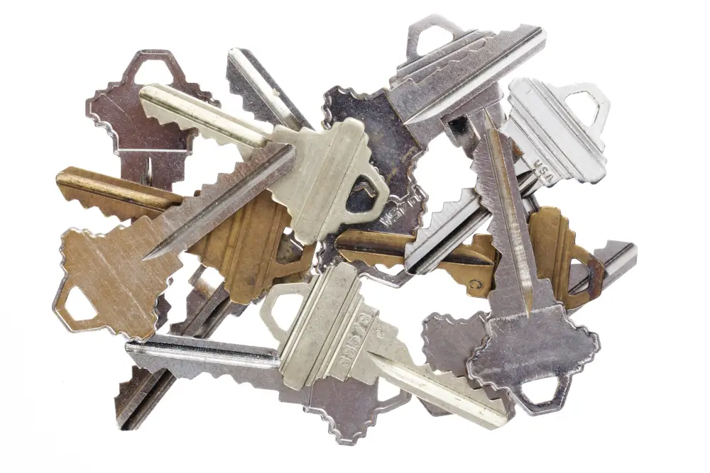 New Home Rekey in El Dorado AR: What to Change Before Your First Night 1 Pile of freshly cut house keys showing why a home rekey matters after buying a house
