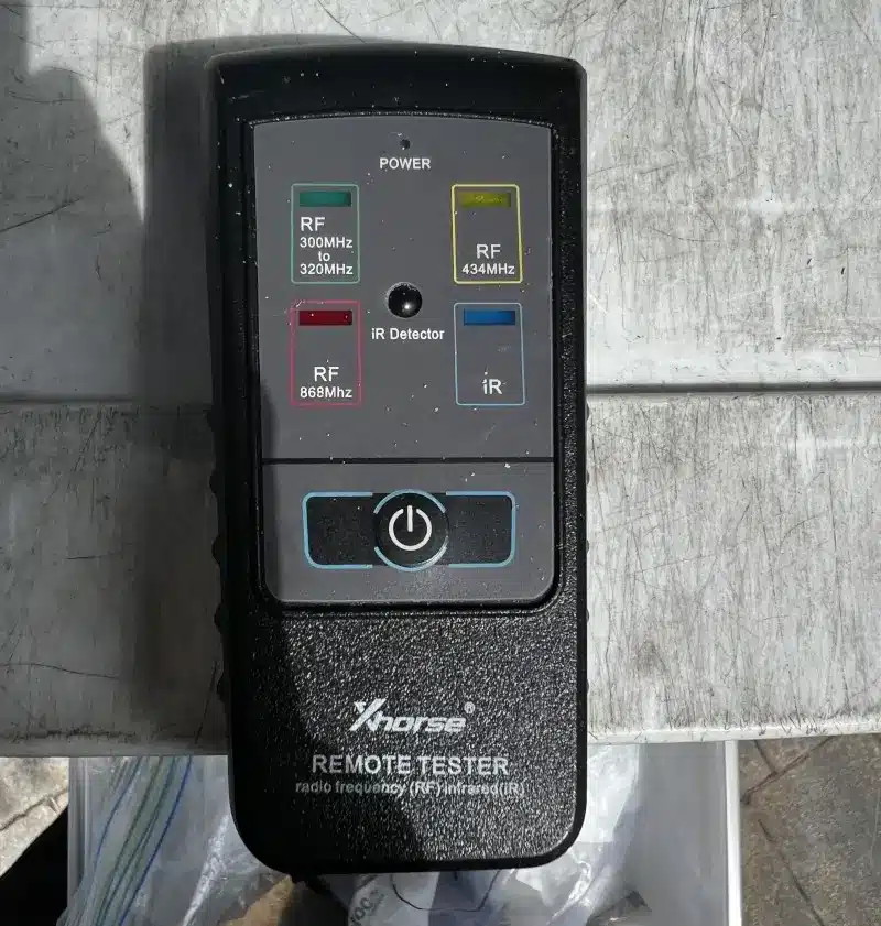 What Does a Lockout Cost in Batesville AR? Real Prices and Response Times for 2026 3 Xhorse remote tester used to diagnose key fob signal during a locksmith service call