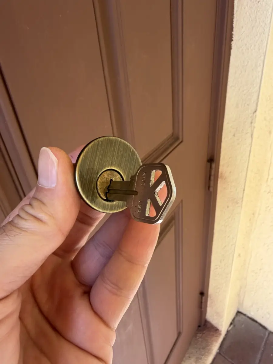 New Home Rekey in El Dorado AR: What to Change Before Your First Night 2 Brass lock cylinder with a Kwikset key removed during a home rekey on an older Arkansas house
