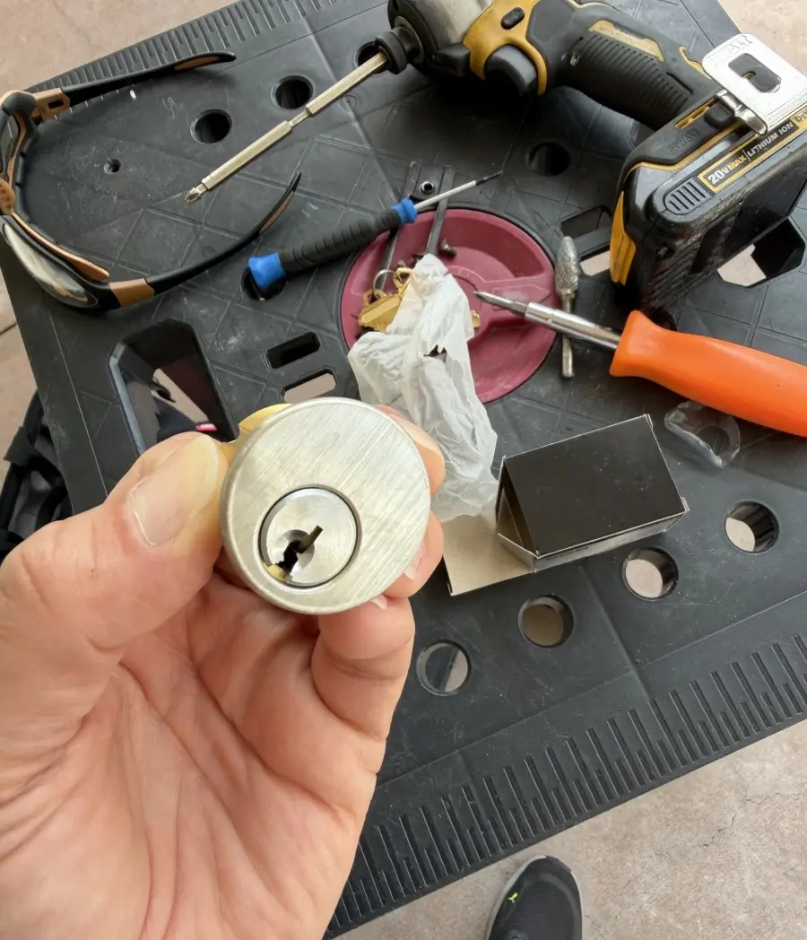 What Does a Lockout Cost in Batesville AR? Real Prices and Response Times for 2026 2 Locksmith holding a residential lock cylinder at a mobile service call in Arkansas